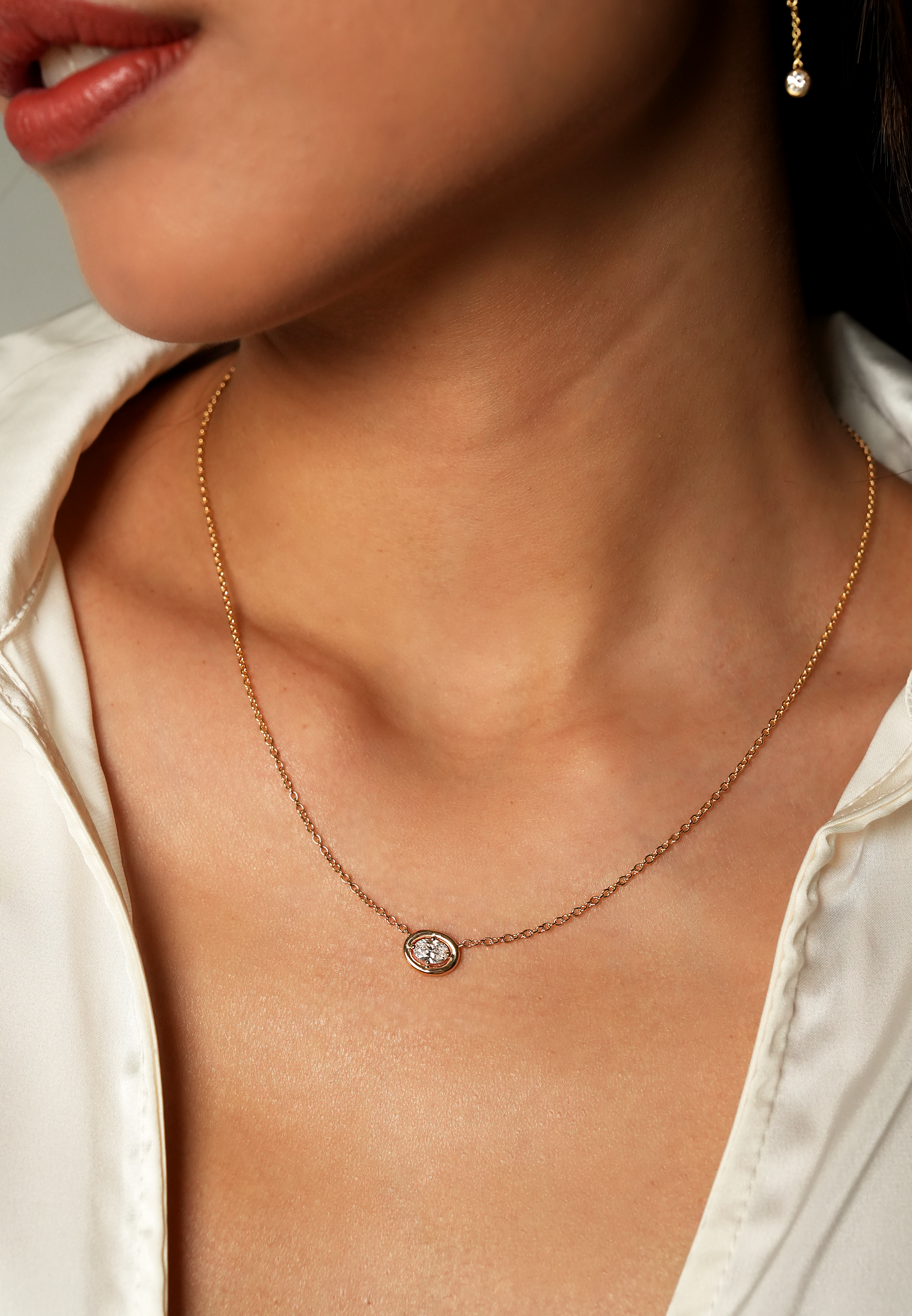 Close-up of a person wearing a Oval Cosmic Diamond Necklace